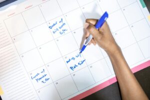Open monthly planner with pen, used for trip planning