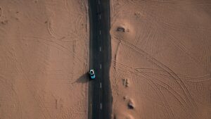 Empty desert road in the UAE leading toward distant mountains
